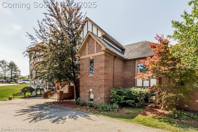 31085 Estate Woods Ct, Farmington Hills, MI 48331 - view of home's exterior featuring brick siding and roof with shingles