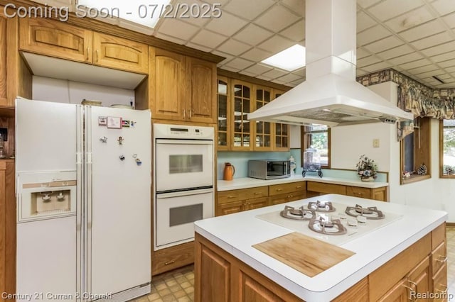 31085 Estate Woods Ct, Farmington Hills, MI 48331 - kitchen with white appliances, island range hood, light countertops, brown cabinetry, and a paneled ceiling