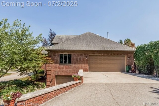 31085 Estate Woods Ct, Farmington Hills, MI 48331 - view of property exterior with brick siding, roof with shingles, driveway, and an attached garage