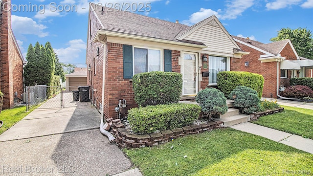 9269 Hubert Ave, Taylor, MI 48101 - bungalow-style house featuring a gate, brick siding, and a shingled roof