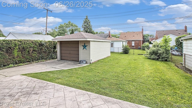 9269 Hubert Ave, Taylor, MI 48101 - view of yard featuring a detached garage, an outbuilding, and concrete driveway