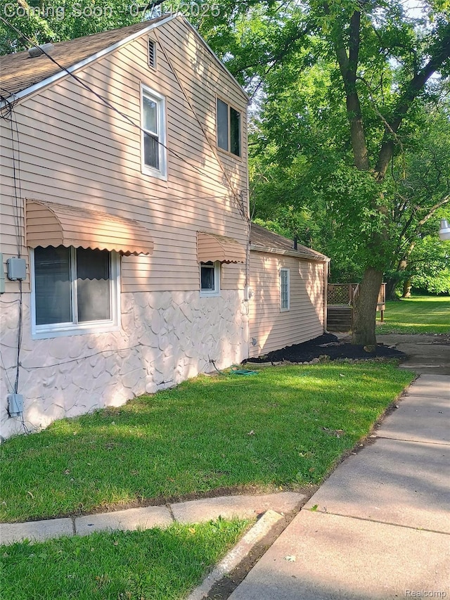 19241 Melrose Ave, Southfield, MI 48075 - view of side of home featuring a lawn and stone siding