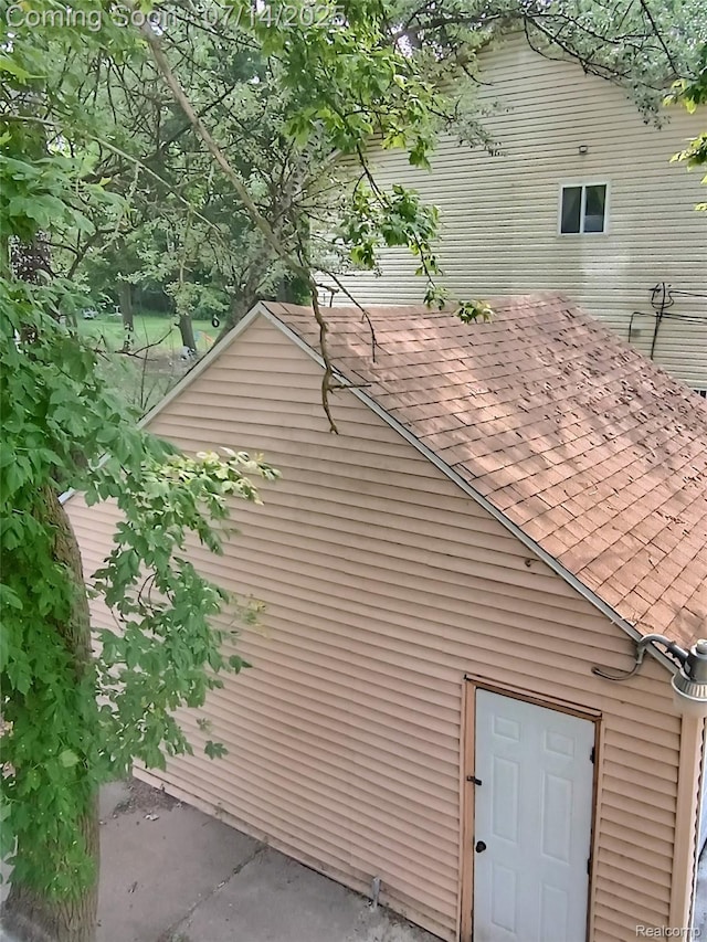 19241 Melrose Ave, Southfield, MI 48075 - exterior view of roof with shingles, gutters, and a downspout