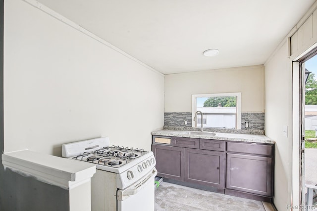 7062 Ready Ave, Warren, MI 48091 - kitchen with white gas stove, tasteful backsplash, light stone counters, and dark brown cabinets