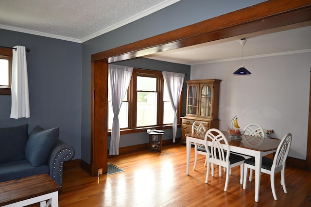 2245 Morton Ave, Muskegon, MI 49441 - dining space featuring healthy amount of natural light, light wood finished floors, ornamental molding, and a textured ceiling