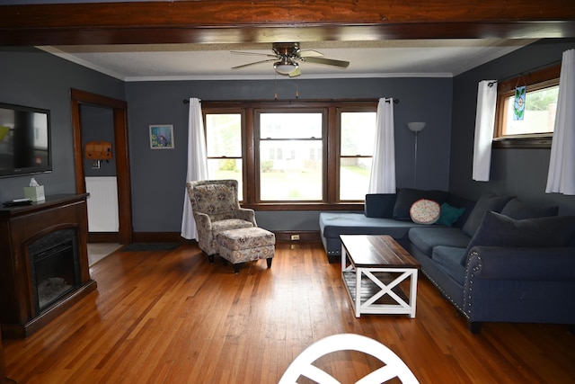 2245 Morton Ave, Muskegon, MI 49441 - living area with wood finished floors, a ceiling fan, a fireplace, and ornamental molding