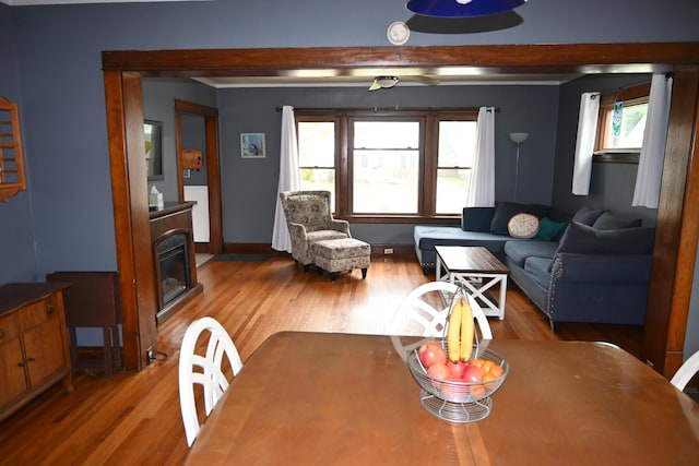 2245 Morton Ave, Muskegon, MI 49441 - dining area featuring wood finished floors, a glass covered fireplace, and beam ceiling