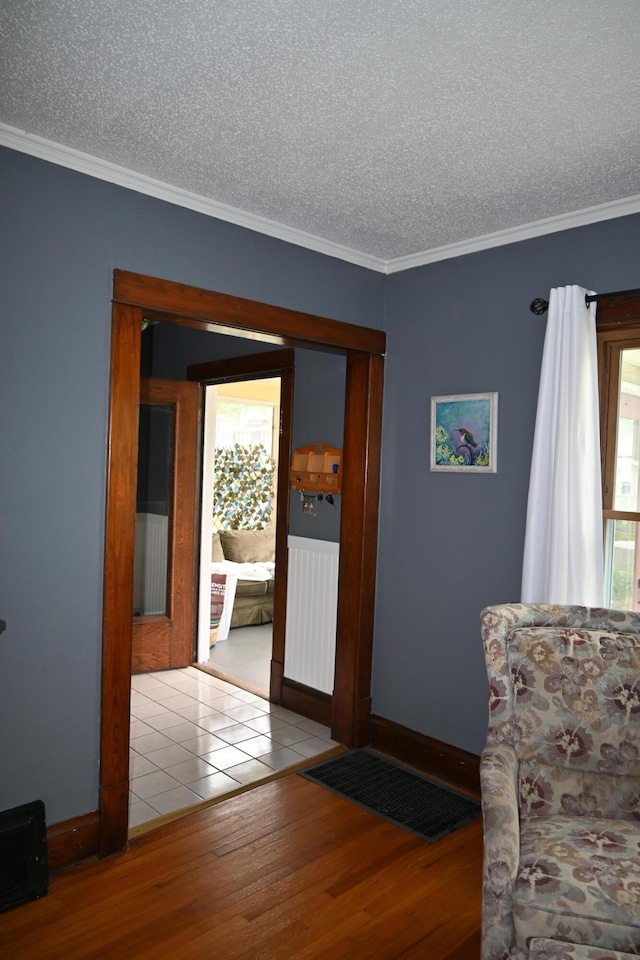 2245 Morton Ave, Muskegon, MI 49441 - sitting room with a textured ceiling, wood finished floors, and crown molding