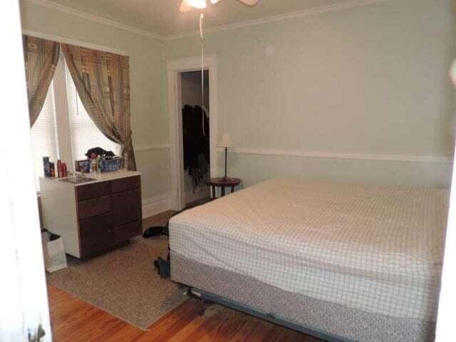 2245 Morton Ave, Muskegon, MI 49441 - bedroom with wood finished floors, crown molding, and a ceiling fan