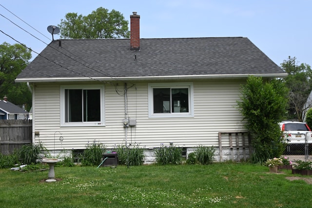 2245 Morton Ave, Muskegon, MI 49441 - back of house with a chimney and roof with shingles