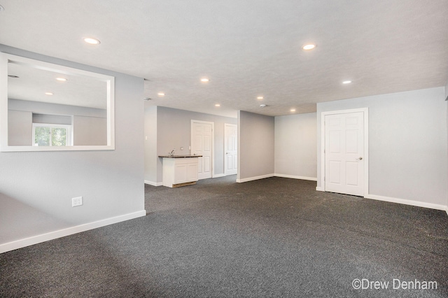 6973 W Blue Water Hwy, Saranac, MI 48881 - unfurnished living room with recessed lighting and dark carpet