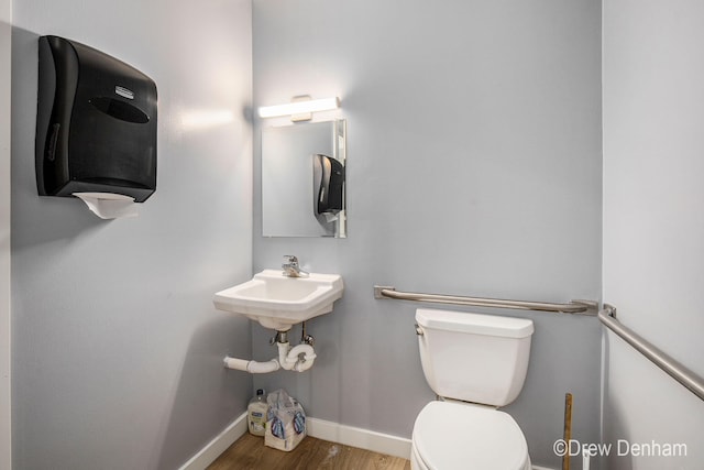 6973 W Blue Water Hwy, Saranac, MI 48881 - half bathroom featuring toilet and wood finished floors