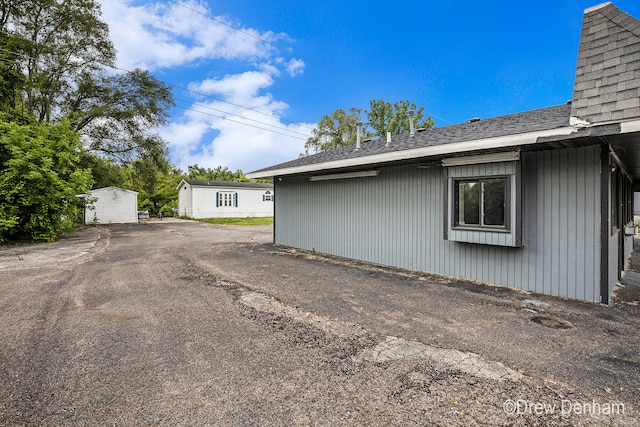 6973 W Blue Water Hwy, Saranac, MI 48881 - view of home's exterior featuring a shingled roof