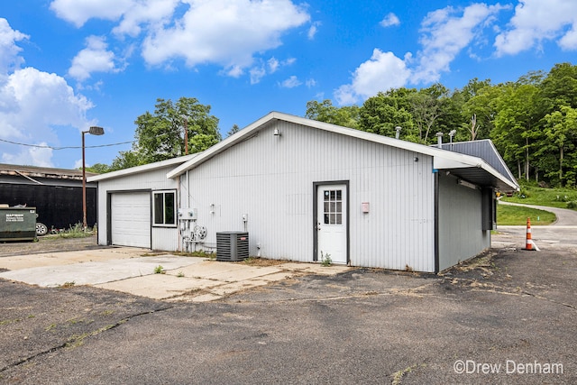 6973 W Blue Water Hwy, Saranac, MI 48881 - view of property exterior with a central air condition unit and a detached garage