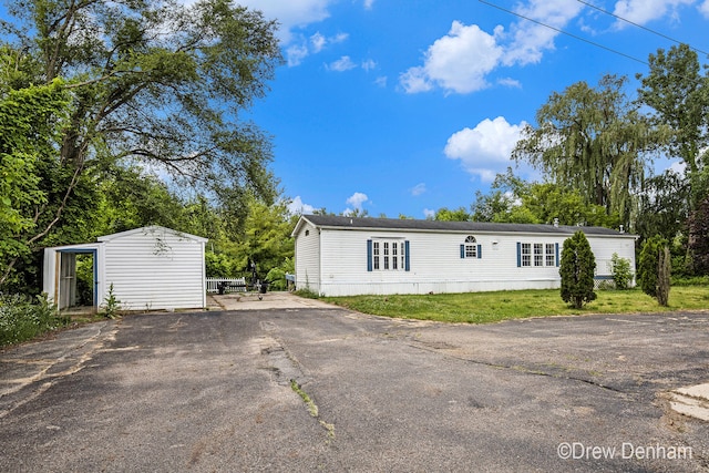 6973 W Blue Water Hwy, Saranac, MI 48881 - view of front facade featuring asphalt driveway and an outdoor structure