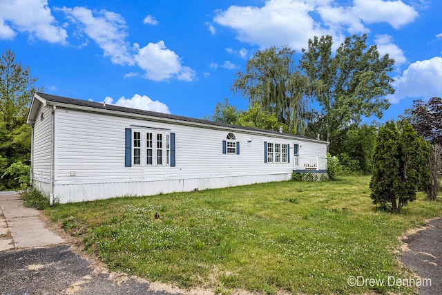 6973 W Blue Water Hwy, Saranac, MI 48881 - manufactured / mobile home with a front yard and a deck