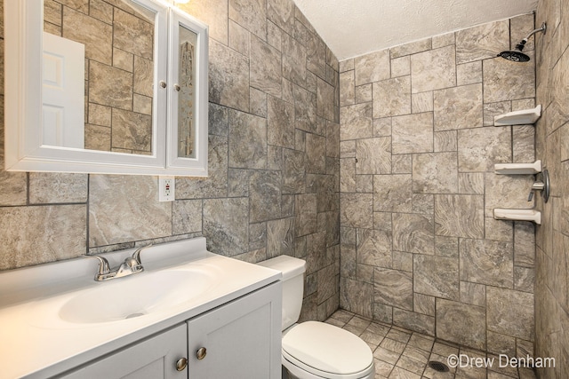 6973 W Blue Water Hwy, Saranac, MI 48881 - full bathroom with tiled shower, vanity, and a textured ceiling