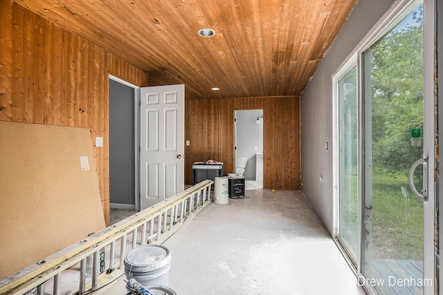 6973 W Blue Water Hwy, Saranac, MI 48881 - hall with wooden ceiling, wood walls, and concrete flooring