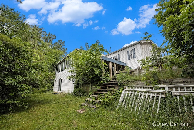 6973 W Blue Water Hwy, Saranac, MI 48881 - back of house featuring stairs, a wooden deck, and a yard