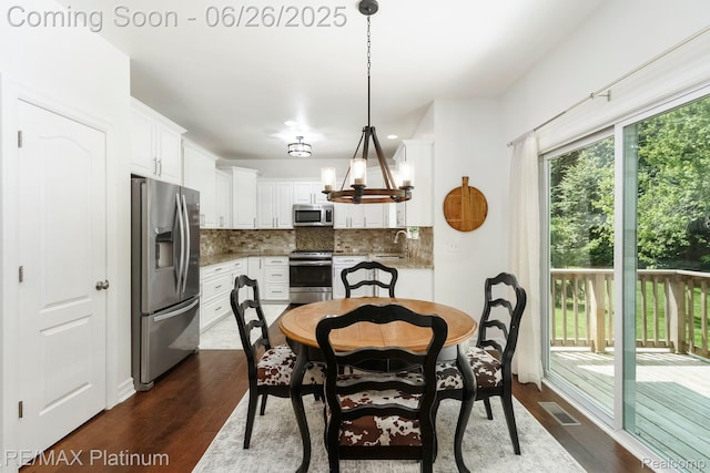 182 Fairhill Way, Howell, MI 48843 - dining room featuring dark wood finished floors and a chandelier