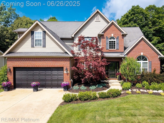 182 Fairhill Way, Howell, MI 48843 - traditional-style house with brick siding, a front yard, concrete driveway, and a garage