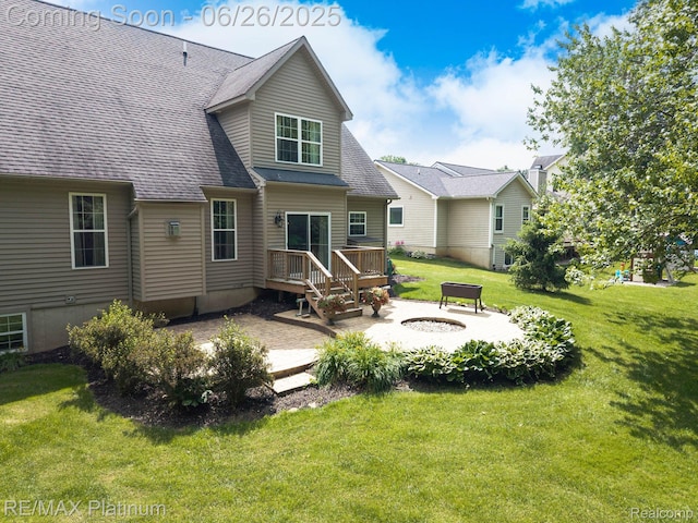 182 Fairhill Way, Howell, MI 48843 - rear view of property featuring a fire pit, a wooden deck, a patio, and a lawn