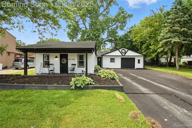 8411 Hugh St, Westland, MI 48185 - view of front of house with covered porch, a garage, and an outdoor structure