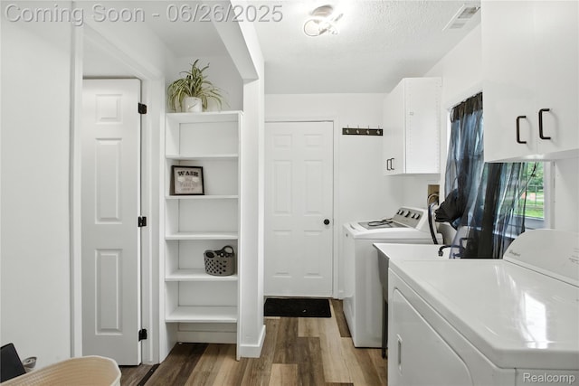 8411 Hugh St, Westland, MI 48185 - washroom featuring cabinet space, washing machine and dryer, wood finished floors, and a textured ceiling