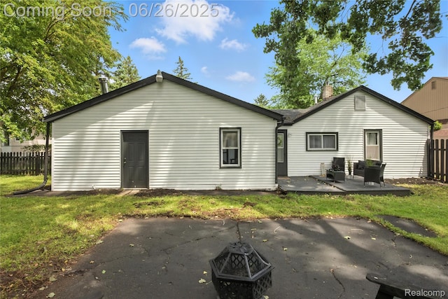 8411 Hugh St, Westland, MI 48185 - back of house featuring a patio, an outdoor fire pit, and a chimney