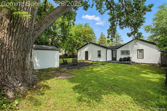 8411 Hugh St, Westland, MI 48185 - rear view of property with a yard, a shed, and a patio