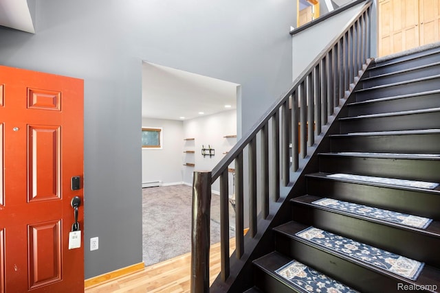 2931 N Lake Pleasant Rd, Attica, MI 48412 - entrance foyer with stairs, baseboard heating, a towering ceiling, wood finished floors, and carpet floors