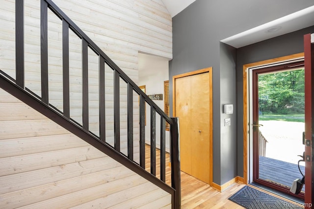 2931 N Lake Pleasant Rd, Attica, MI 48412 - entrance foyer with high vaulted ceiling, stairs, and wood finished floors