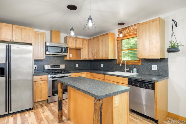 2931 N Lake Pleasant Rd, Attica, MI 48412 - kitchen with stainless steel appliances, dark countertops, light wood finished floors, and light brown cabinets