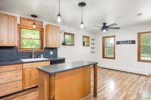 2931 N Lake Pleasant Rd, Attica, MI 48412 - kitchen with a baseboard heating unit, dark countertops, backsplash, and light brown cabinetry