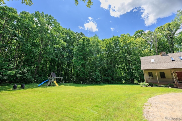 2931 N Lake Pleasant Rd, Attica, MI 48412 - view of green lawn with a porch and a playground