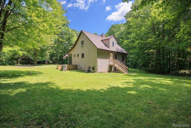 2931 N Lake Pleasant Rd, Attica, MI 48412 - view of home's exterior with a chimney, stairway, and a yard