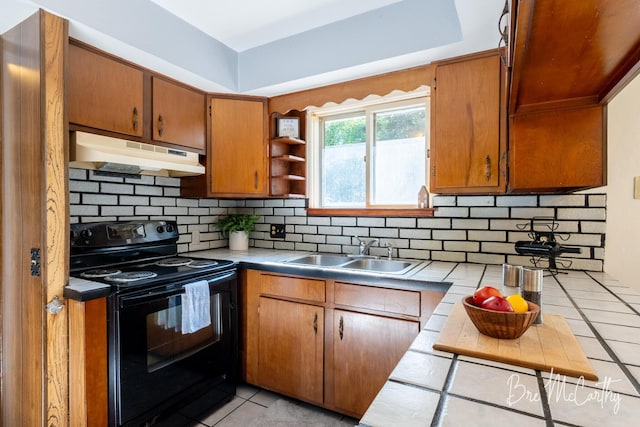 3541 Orshal Rd, Whitehall, MI 49461 - kitchen featuring black range with electric stovetop, under cabinet range hood, light tile patterned floors, and tasteful backsplash