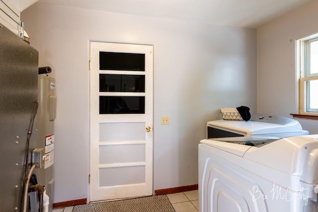 3541 Orshal Rd, Whitehall, MI 49461 - laundry room featuring washer and clothes dryer, light tile patterned flooring, and electric water heater