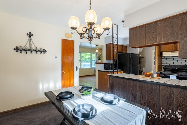 3541 Orshal Rd, Whitehall, MI 49461 - dining space featuring a chandelier and dark carpet