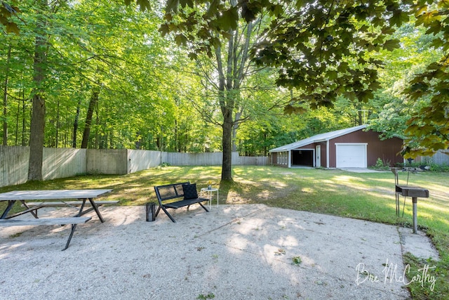 3541 Orshal Rd, Whitehall, MI 49461 - view of patio featuring a detached garage and an outdoor structure