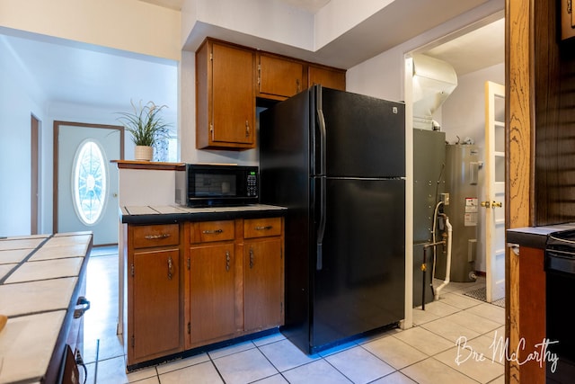 3541 Orshal Rd, Whitehall, MI 49461 - kitchen with black appliances, brown cabinetry, water heater, and light tile patterned flooring