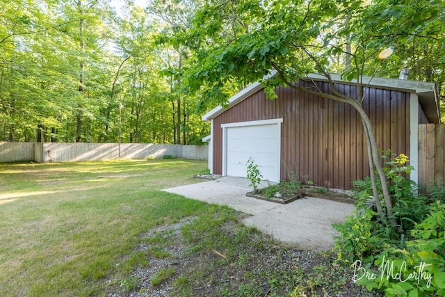 3541 Orshal Rd, Whitehall, MI 49461 - fenced backyard featuring a detached garage, an outbuilding, and driveway