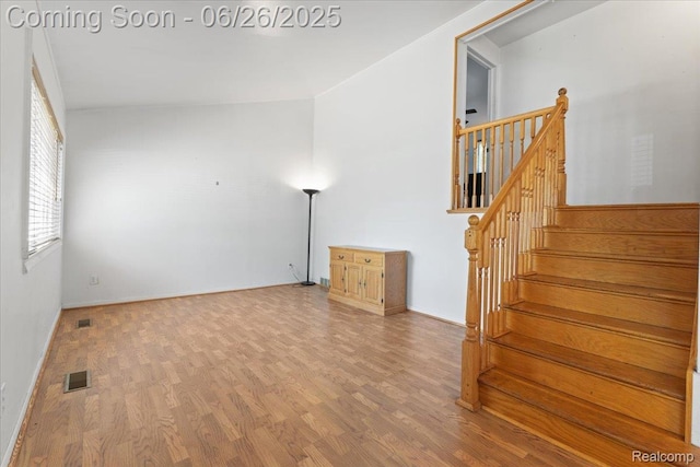 1070 Dreon Dr, Clawson, MI 48017 - spare room featuring wood finished floors and stairs