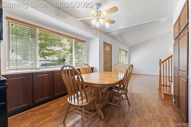 1070 Dreon Dr, Clawson, MI 48017 - dining room featuring vaulted ceiling, wood finished floors, a ceiling fan, and stairs