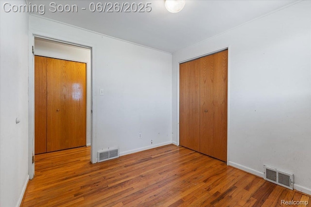 1070 Dreon Dr, Clawson, MI 48017 - unfurnished bedroom with wood finished floors and a closet