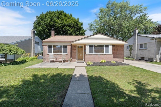 1070 Dreon Dr, Clawson, MI 48017 - view of front of house with brick siding, a front lawn, and a chimney
