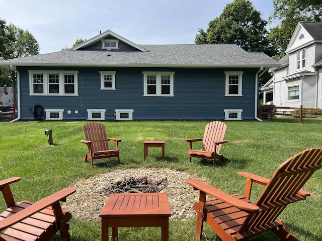 950 College Ave, Adrian, MI 49221 - back of house featuring a fire pit, a lawn, and roof with shingles
