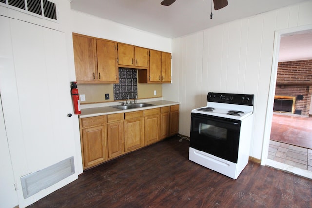 22779 Almond Ave, Eastpointe, MI 48021 - kitchen with electric range oven, a ceiling fan, light countertops, dark wood finished floors, and brown cabinetry
