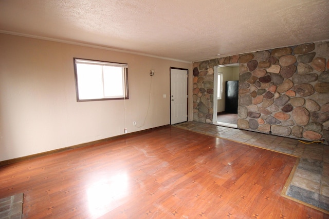 22779 Almond Ave, Eastpointe, MI 48021 - spare room with wood finished floors, a textured ceiling, and ornamental molding