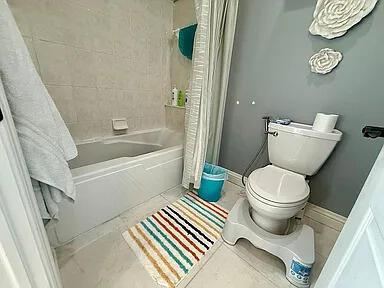 8255 Shady Brook Ln, Flushing, MI 48433 - bathroom with shower / bath combination with curtain and toilet